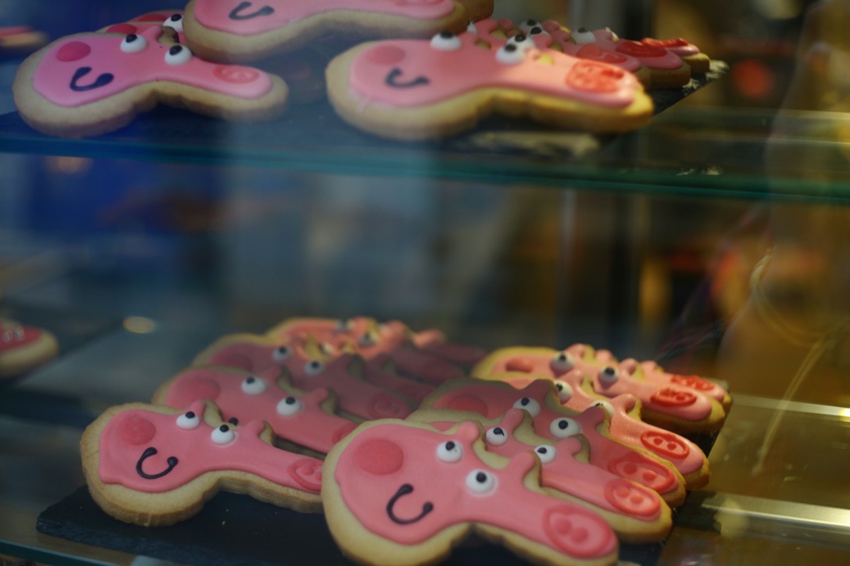 Pink decorated cookies on bakery shelves